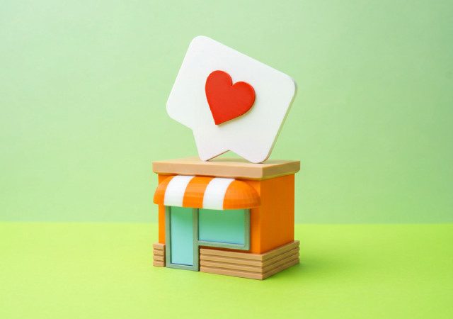 Ilustración 3D de una tienda online naranja con un corazón rojo sobre ella que representa la interacción y el engagement en redes sociales